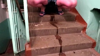 Pissing In Shorts At An Entrance To The Stairs
